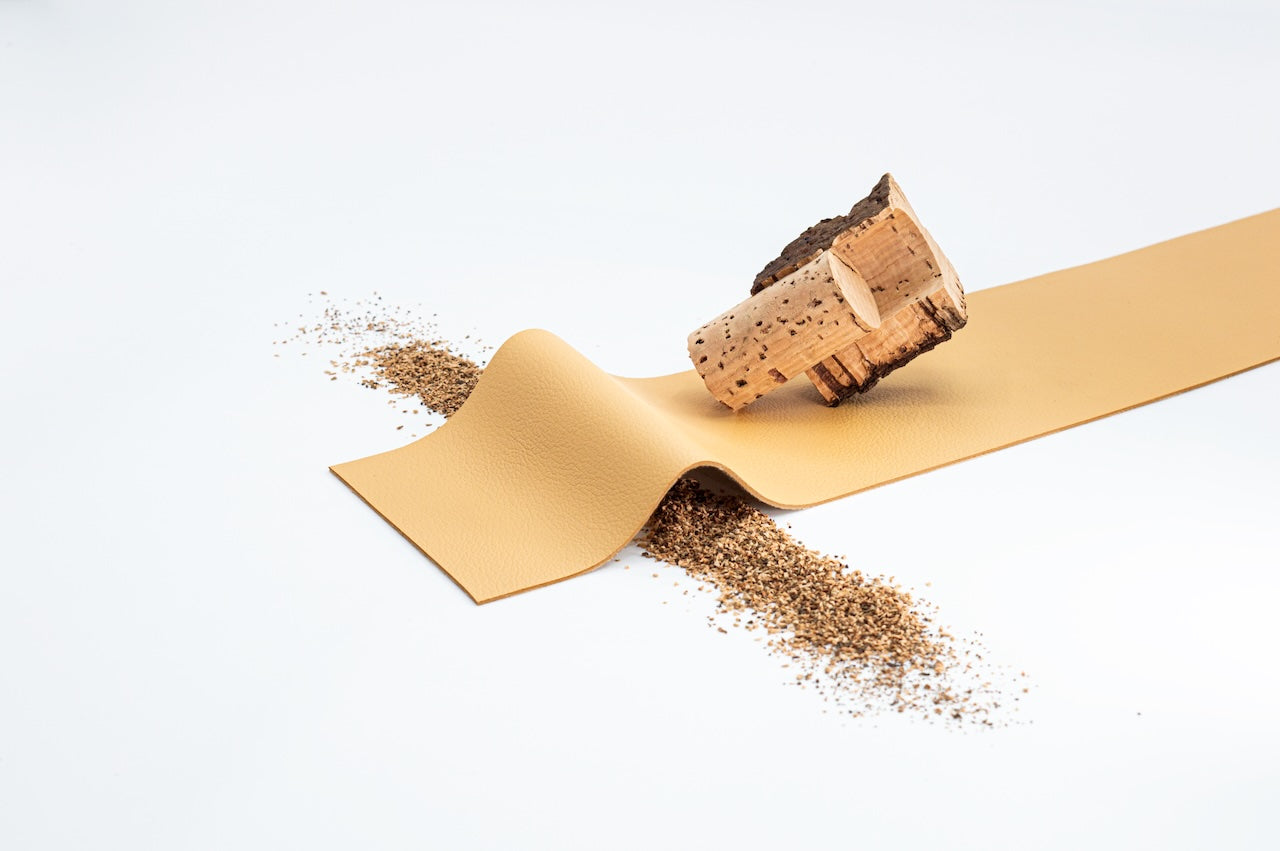 Cork with sawdust on a beige ribbon against a white background