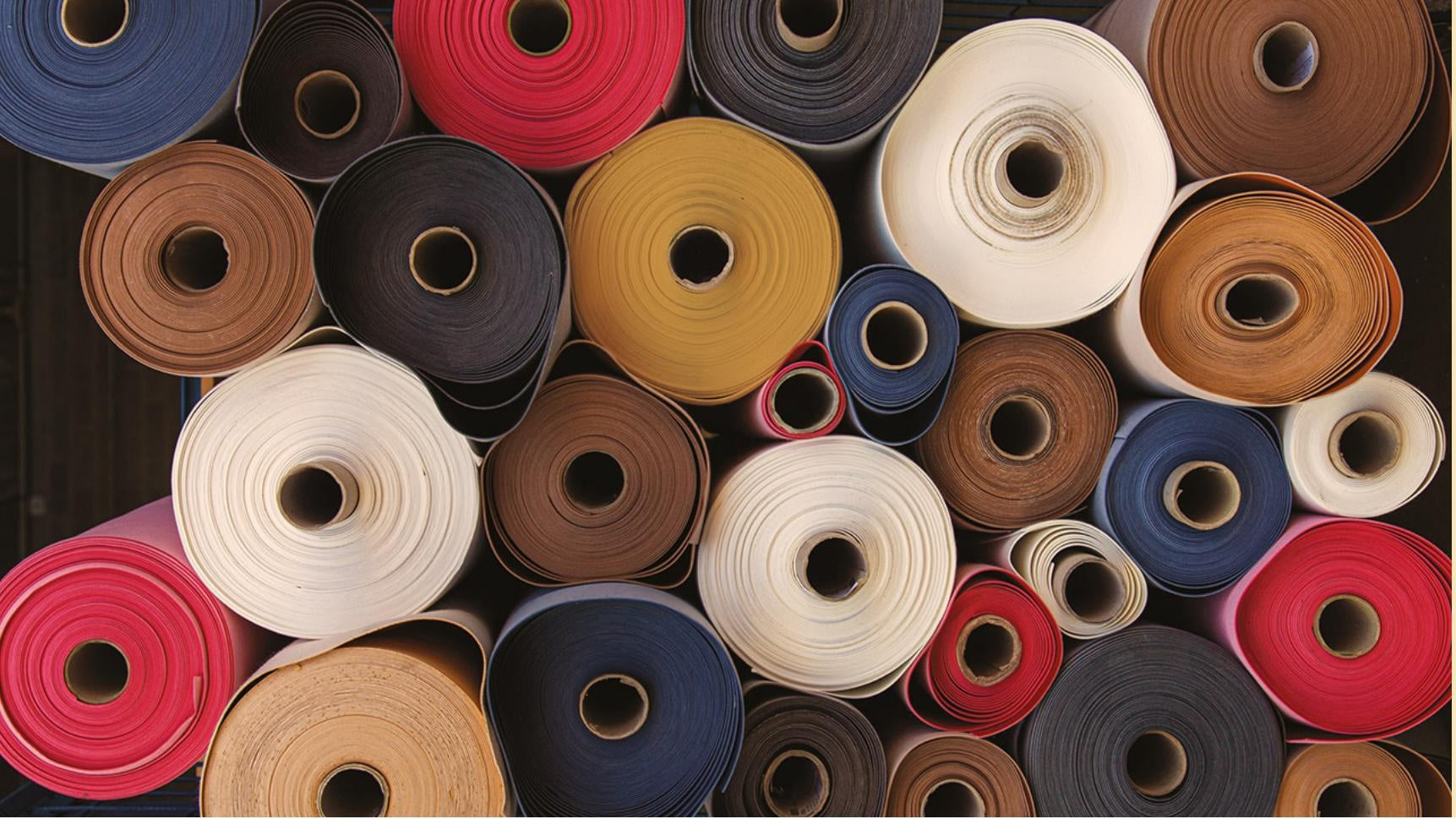 Collection of colorful fabric rolls arranged in a pattern