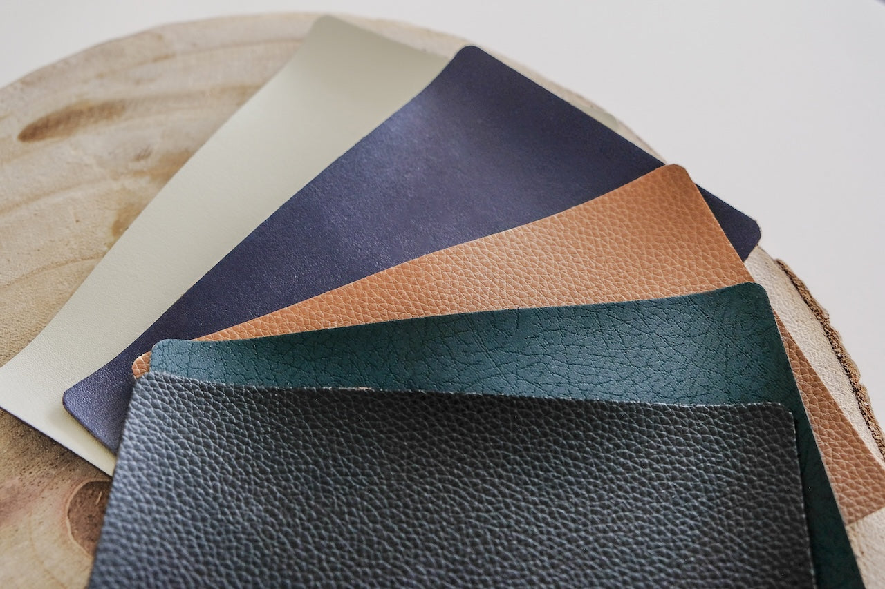 Collection of Bio-innovative material  samples in various colors on a wooden surface