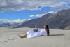 Waves bag held by model in a sandy landscape